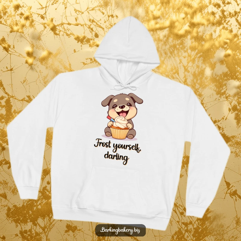 Funny dog hoodie illustration of a gleeful dog with a big smile, proudly frosting a cupcake with a generous amount of frosting.